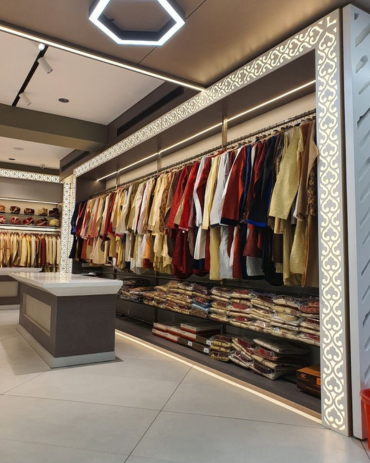 Spacious cloth showroom interior design with display racks